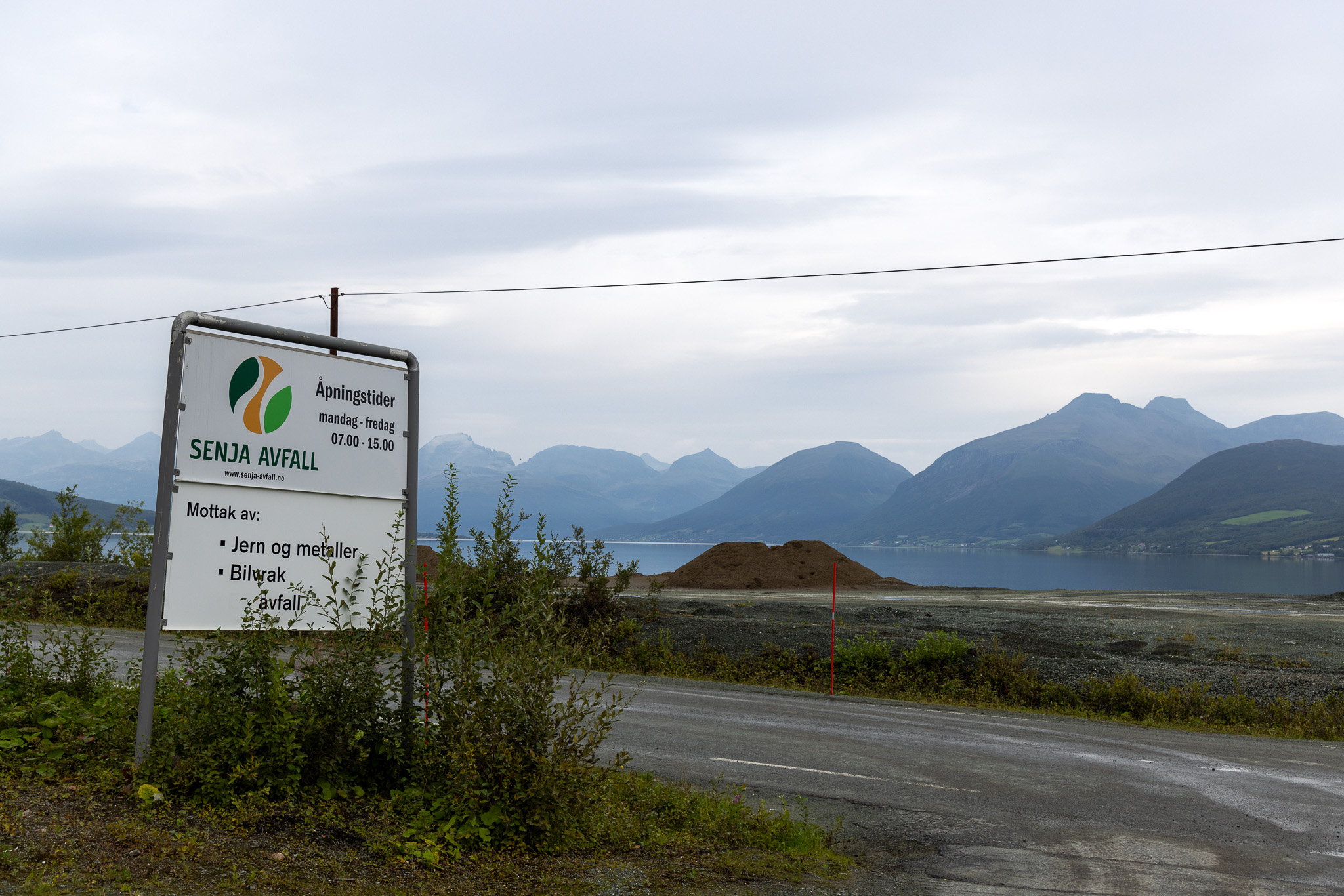 a sign in front of mountains