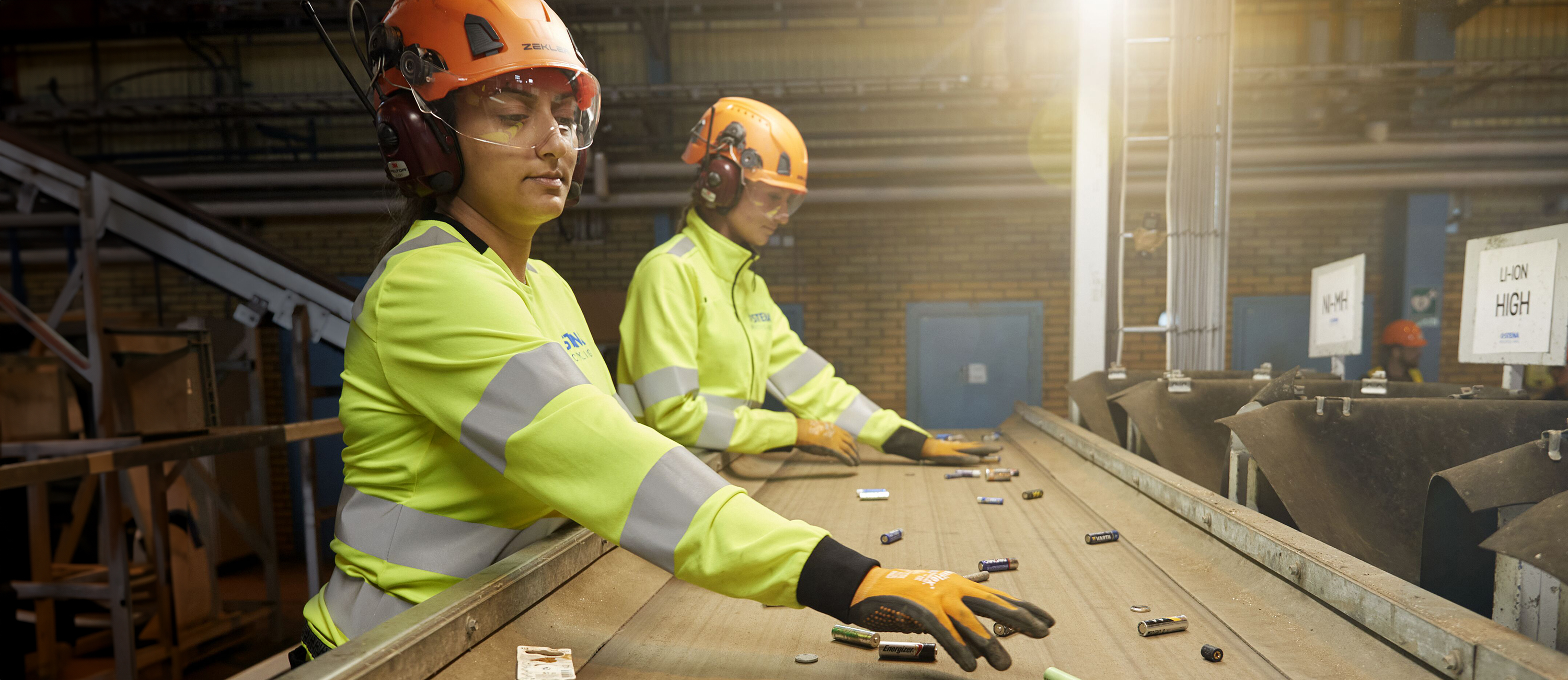 Varselklädd personal hanterar batterier