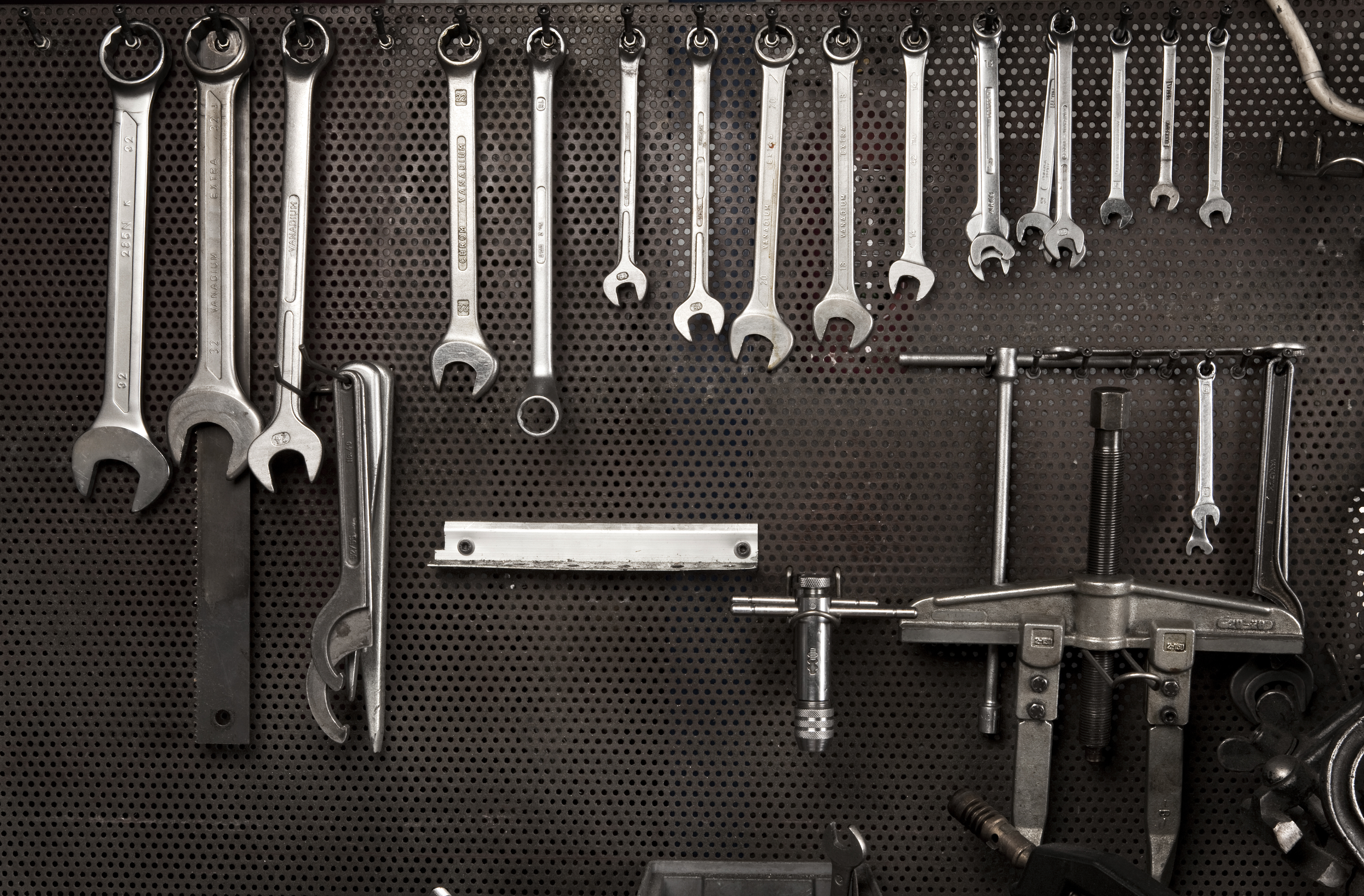 An array of tools hanging on a wall.