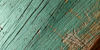 Close-up of a worn, green-painted piece of waste wood ready for recycling