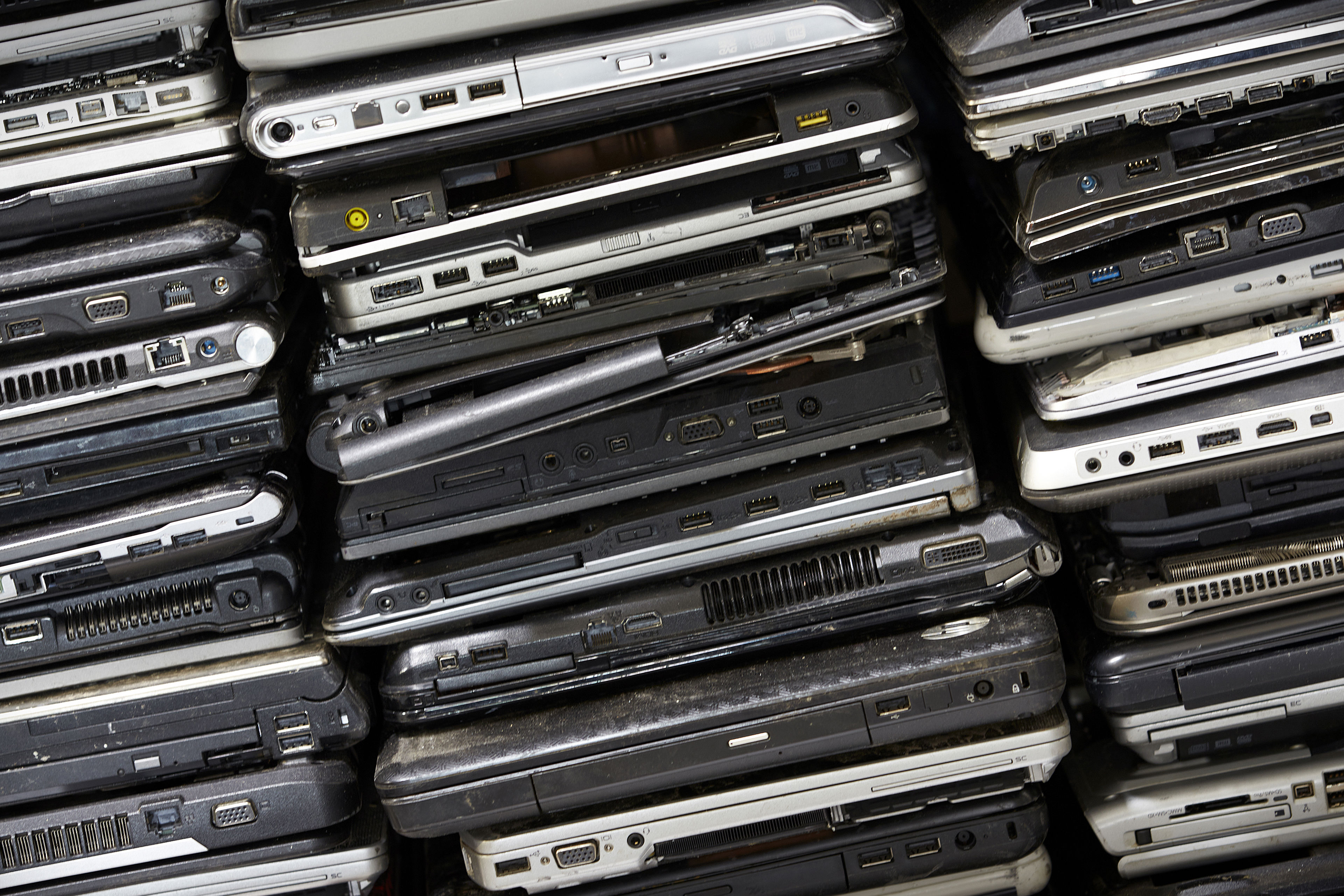 A pile of laptop computers ready to be reused or recycled by Stena Recycling.